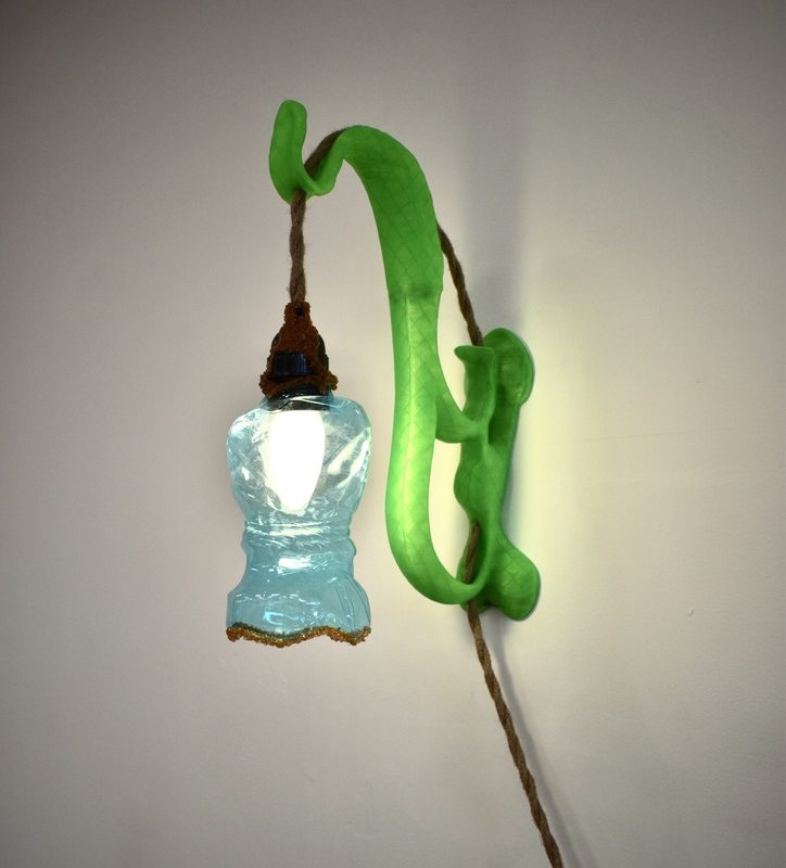 Wall light with a green recycled-plastic arm and blue plastic bottle lampshade