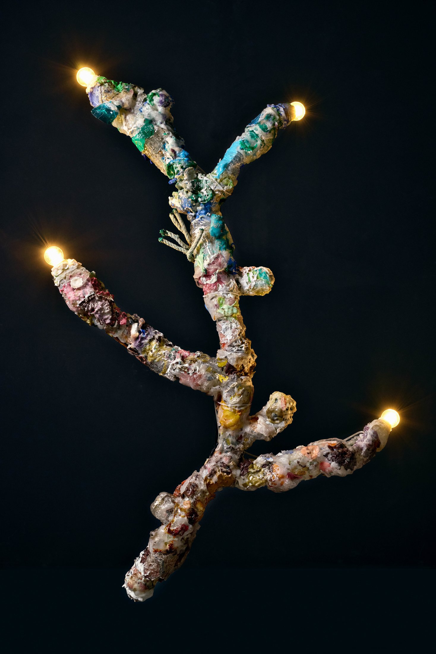 Coral lamp: a branching lamp covered in plastic fragments with bulbs at its tips