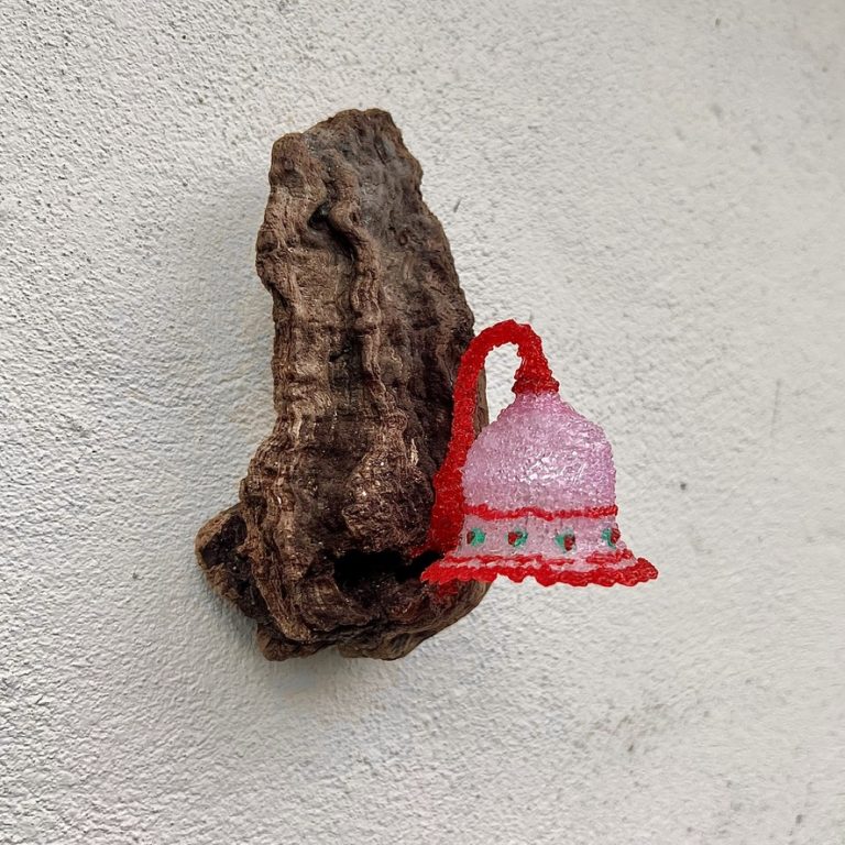 Driftwood wall lamp by Coline Le Quenven: found beach wood with a pink and red recycled plastic bell shade