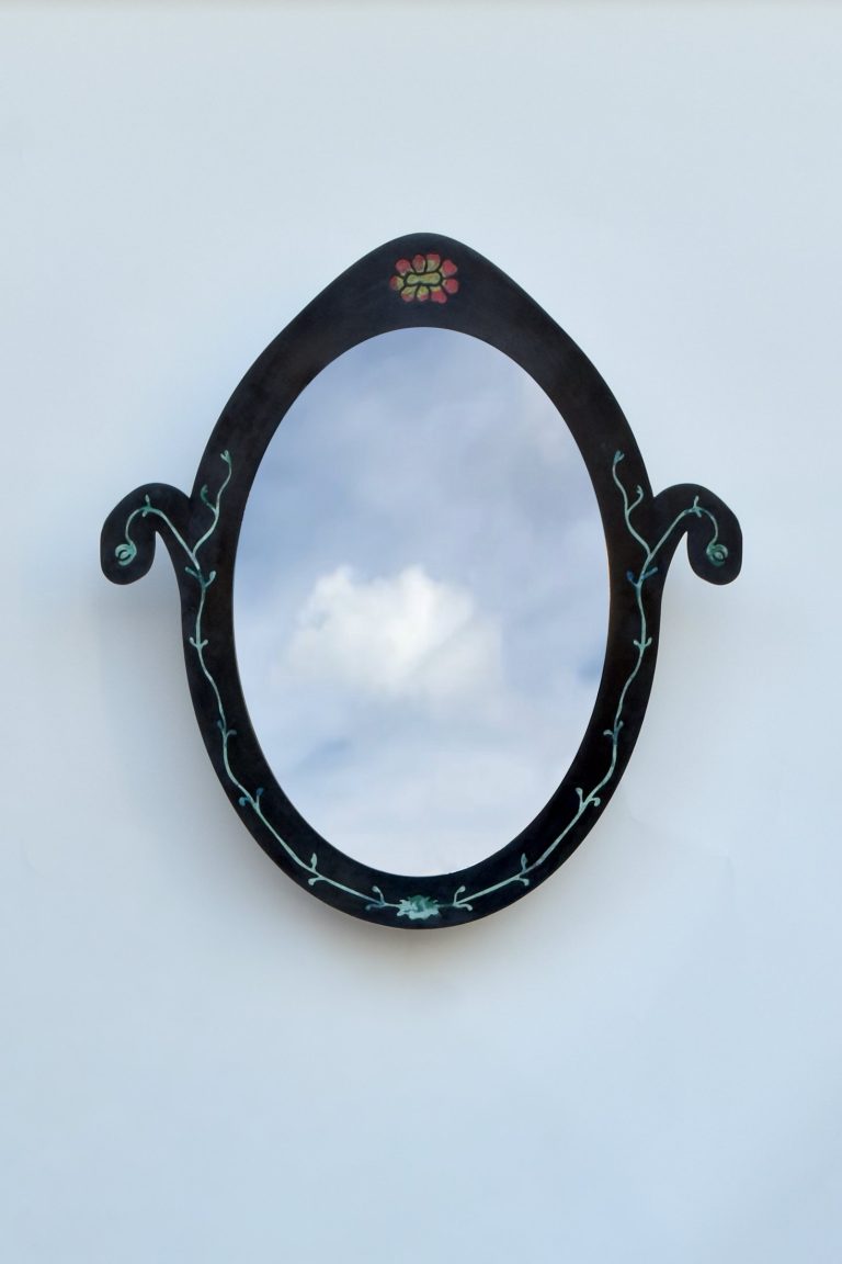Pietra Plastica oval mirror in black steel inlaid with recycled plastic vines and a small rosette