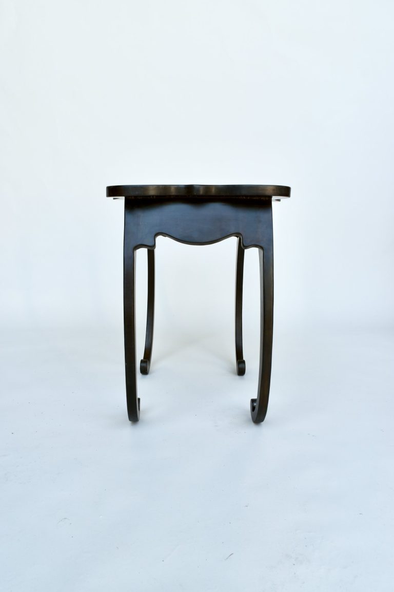 Pietra Plastica side table in black patinated steel with curling legs