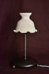 Small lamp with a white ruffled recycled-plastic shade on a dark metal stand
