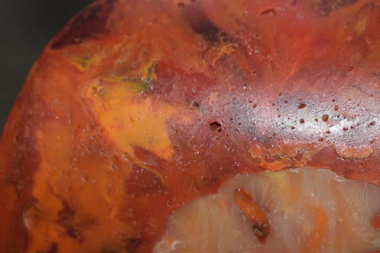 Close-up of a wall sconce: red and orange melted plastic like marble