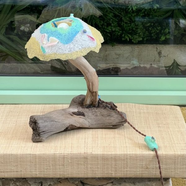Driftwood lamp with a beach-plastic shade on a piece of found wood