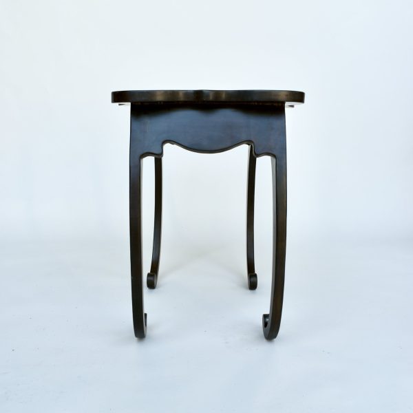Pietra Plastica side table in black patinated steel with curling legs
